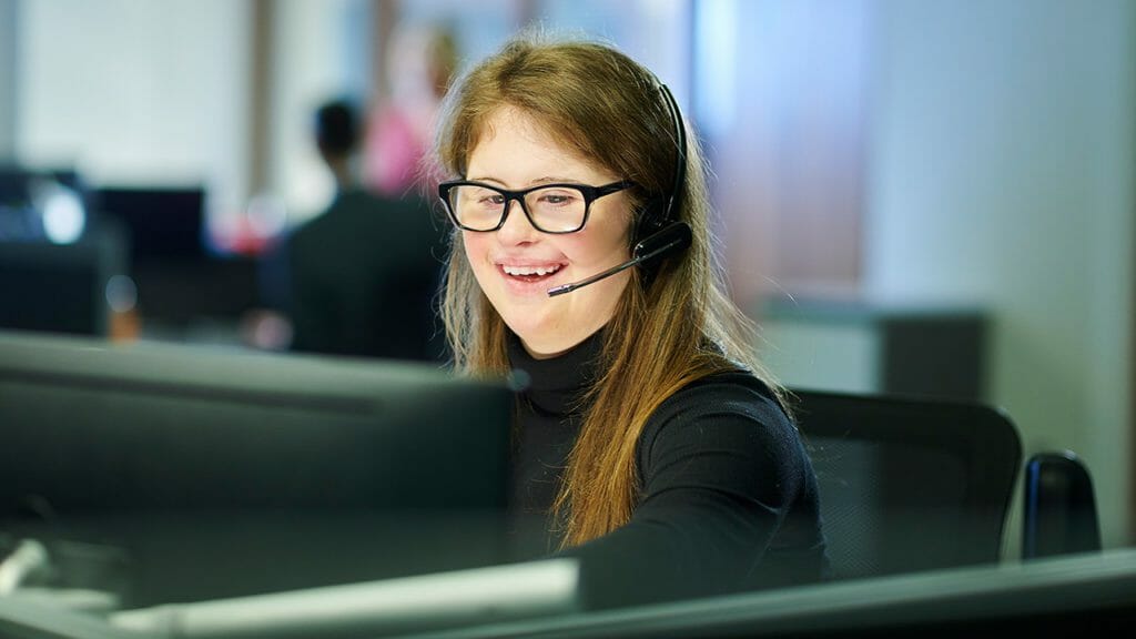 Disabled girl at work in a contact centre